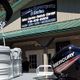Exterior of a Powersports and Marine store with a Mercury outboard motor display.