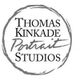 Logo with text: "Thomas Kinkade Portrait Studios" in a circular brushstroke design.