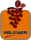 Logo mit Traubensymbol und Blatt, darunter der Schriftzug "Ablinger" in Großbuchstaben.