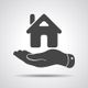 Hand holding a house icon, symbolizing real estate or home insurance.