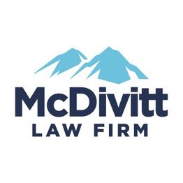 Logo of McDivitt Law Firm with blue mountains and bold text on a white background.