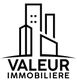 Logo noir d'immeubles stylisés avec le texte "VALEUR IMMOBILIERE" en dessous.