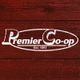 Logo reading "Premier Co-op Est. 1893" on a textured red wooden background.