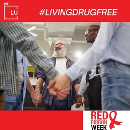 A diverse group holding hands in solidarity, with a #LivingDrugFree Red Ribbon Week banner above.