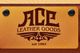 Logo for Ace Leather Goods, established in 1982, on a textured brown leather background.