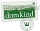 Grünes Logo "domkind" mit Briefmarken-Design und Krone, Text: "Agentur für nachhaltiges Marketing".