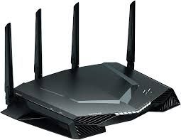 A sleek black Wi-Fi router with four antennas and angular design.