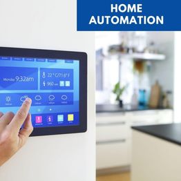 Touchscreen displaying home automation controls and weather, with a finger interacting with it.