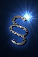 Paragraphenzeichen vor blauem Hintergrund mit Lichteffekt oben rechts.