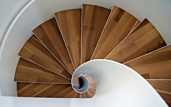 Eine Wendeltreppe aus Holz, aufgenommen aus der Vogelperspektive.