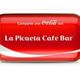 Lata roja de Coca-Cola con texto "La Picaeta Cafe Bar".
