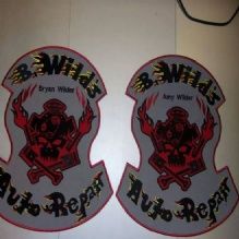 Two identical patches labeled "B.Wild's Auto Repair" with a flaming skull and crossed wrenches design.