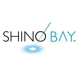 Shino Bay logo featuring a stylized needle and light beam effect.