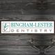 Logo of "Bingham-Lester Dentistry" on a wooden background.