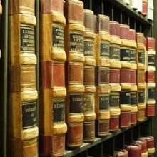 Close-up of vintage law books lined up on a library shelf.