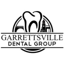 Logo of Garrettsville Dental Group with a tooth and building silhouette in black and white.
