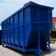 Large blue industrial dumpster in an outdoor setting under a clear sky.