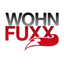 Logo mit dem Text "WOHN FUXX" und einem stilisierten roten Fuchskopf unter dem Text.
