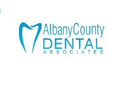 Logo of Albany County Dental Associates with a tooth graphic in blue.