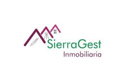 Logotipo de SierraGest Inmobiliaria con ilustraciones de montañas y casas en tonos morado y verde.