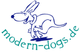 Cartoon-Hund mit der Aufschrift "modern-dogs.de" in geschwungener Schrift.