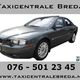 Grijze sedan met tekst: "Taxicentrale Breda" en contactgegevens.