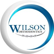Logo of Wilson Orthodontics with a crescent design and braces illustration below the text.