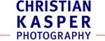 Logo mit dem Text „CHRISTIAN KASPER PHOTOGRAPHY“ in blauer Schrift.