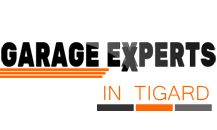 "Garage Experts in Tigard logo with orange and black text and lines."