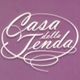 Scritta "Casa della Tenda" bianca su sfondo viola.