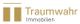 Logo von Traumwahr Immobilien in Gold und Weiß mit zwei vertikalen Balken links.