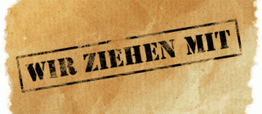 Stempel auf braunem Papier mit der Aufschrift "WIR ZIEHEN MIT" in Großbuchstaben.
