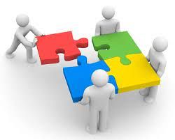 Four figures connecting four puzzle pieces in red, green, blue, and yellow.