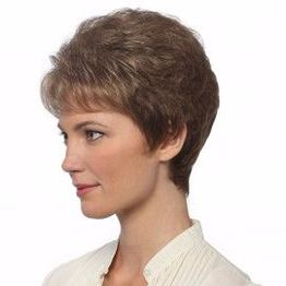 Woman with short, brown hair looks left, wearing a white blouse, neutral background.