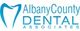 Logo of Albany County Dental Associates with a stylized tooth design in blue.