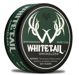 Green can of Whitetail Smokeless Wintergreen tobacco, featuring antler logo. Warning label visible.