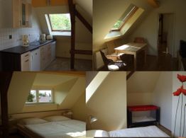 Dachgeschosswohnung mit Küche, Essbereich, Schlafzimmer und Kinderbett, gemütlich und hell.