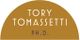 Tory Tomassetti Ph.D. logo on a mustard semi-circle background.