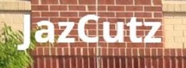 "Sign reading 'JazCutz' on a brick wall background."