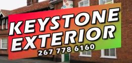 Keystone Exterior sign with phone number, 267 778 6160, in front of a brick building.