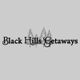 "Black Hills Getaways logo with silhouette of trees in the background."