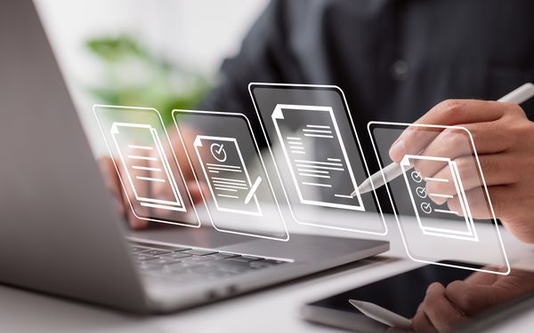 Ein Mitarbeiter einer Firma erledigt die aktuelle Lohn- und Gehaltsabrechnung, am Laptop.