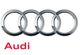Audi logo with four silver rings and the word "Audi" in red below.