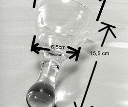 Transparentes Glas auf Tisch, Breitenmaße: 8,8 cm, 6,5 cm, Länge: 15,5 cm, mit schwarzen Pfeilen.