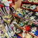 Colorful Venetian masks on shelves, including ornate jester and carnival designs.