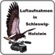 Adler sitzt auf einer Kamera. Text: "Luftaufnahmen in Schleswig-Holstein".