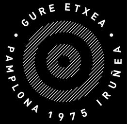 Logotipo circular con el texto "Gure Etxea, Pamplona 1975 Iruñea" y un diseño de espiral.