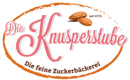 Ein ovales Logo von "Die Knusperstube" mit Mandeln und dem Text "Die feine Zuckerbäckerei".