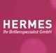 HERMES-Logo mit dem Text "Ihr Brillenspezialist GmbH" auf einem magentafarbenen Hintergrund.
