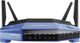 Blue Linksys Wi-Fi router with four antennas, front view displaying indicator lights.